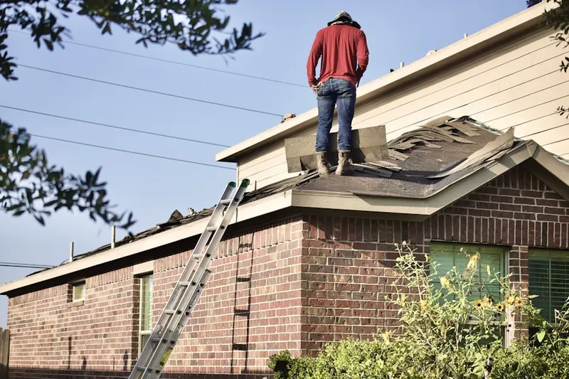 Professional roofer working on a residential roof in Stonehaven Place